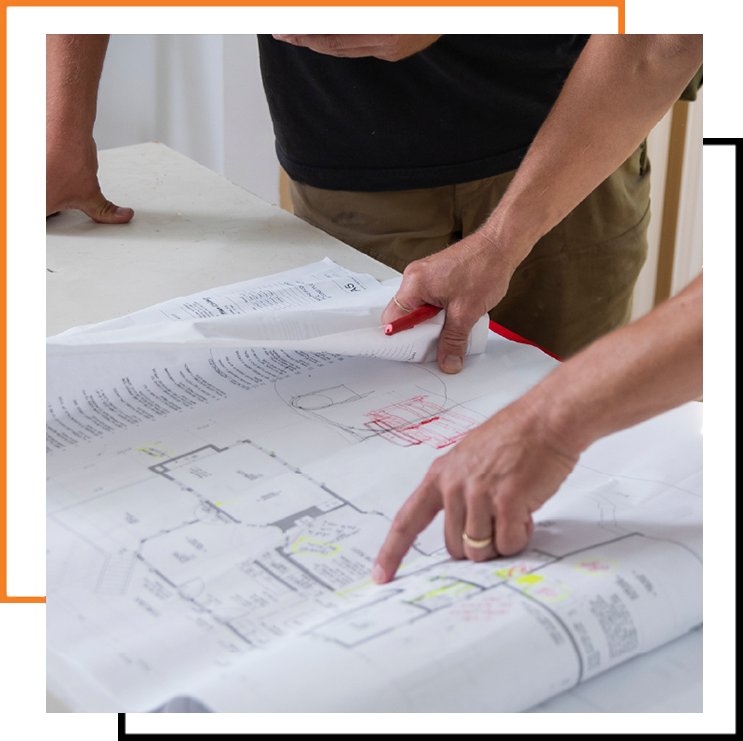 Team reviewing blueprints and schedules for effective construction planning.